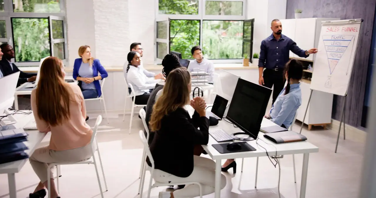 Office workers at desks with computers, woman at monitor (office interior).